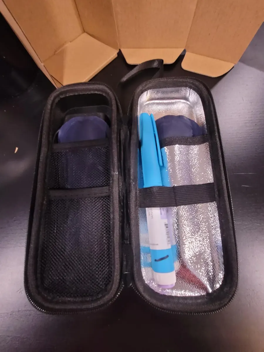 Customer photo: the case open in its shipping box, a pen strapped inside